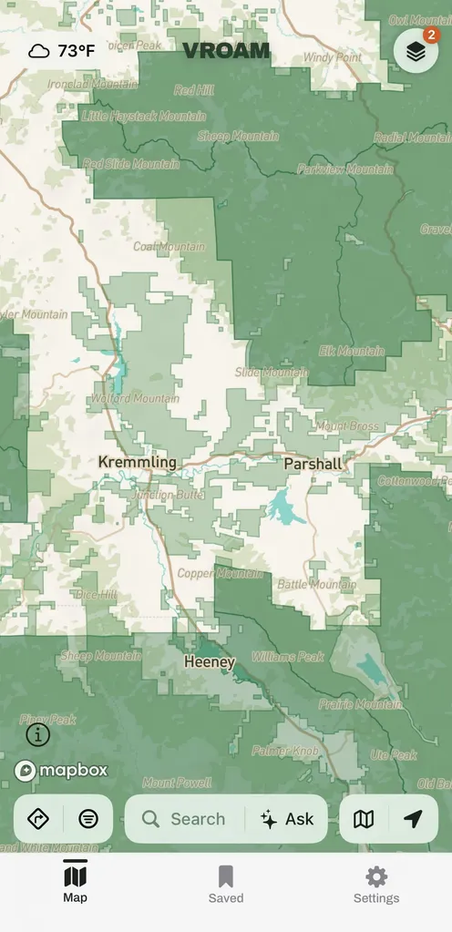 Vroam's land overlay over Kremmling and Parshall, Colorado, with public land shaded by who manages it: a deep green block filling the north and east of the frame with its boundary drawn as a line, paler green parcels stepping down in blocks to the west and south, and unshaded white ground between them where no public land is drawn, under a temperature pill and the Layers button.